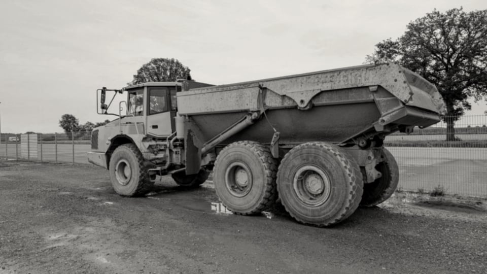 Aggregate-laden tipper lorry on a UK road, en route to a buyer site
